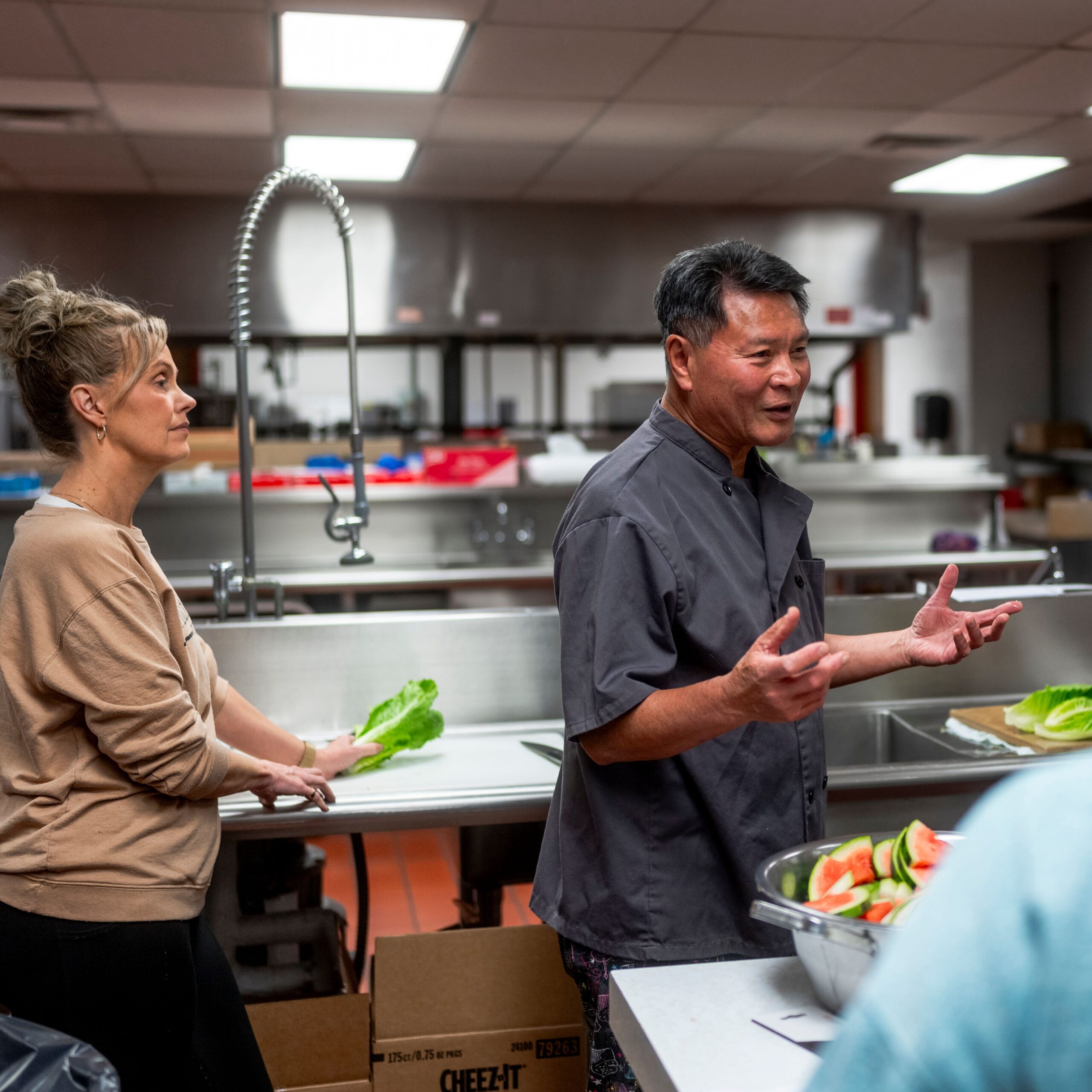 Chef Art Chin teaching knife skills to local cafeteria staff Image 1